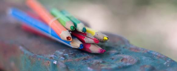 A bundle of broken colored pencils that need to be repaired