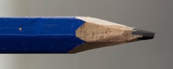 A pencil that has been sharpened with a knife