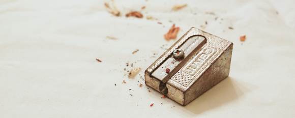 A Jumbo manual pencil sharpener with some pencil shavings