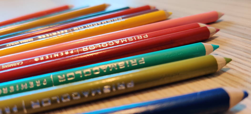 Prismacolor colored pencils on a desk