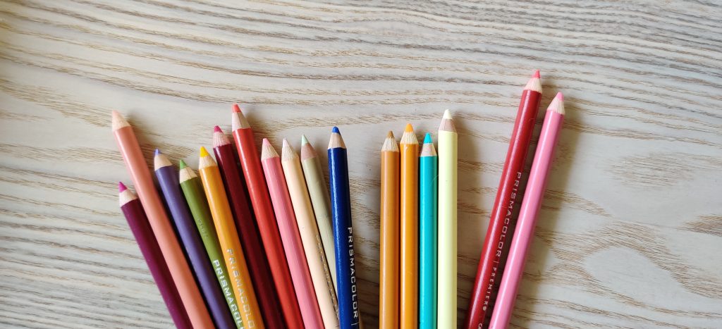 Prismacolor colored pencils on a wood table